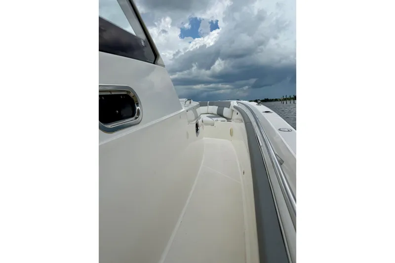 Slide: The Image of 2020 Pursuit S 408 Sport boat on water under cloudy sky. - 10