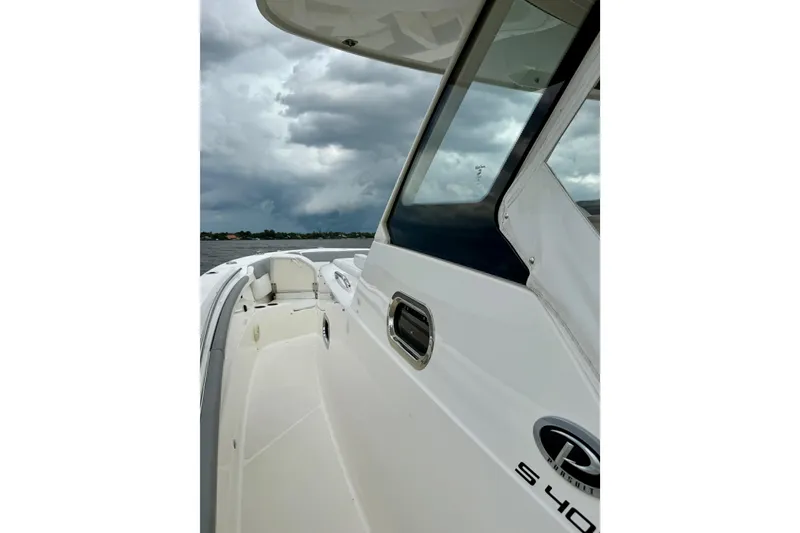 Slide: The Image of 2020 Pursuit S 408 Sport boat on water under cloudy sky. - 11