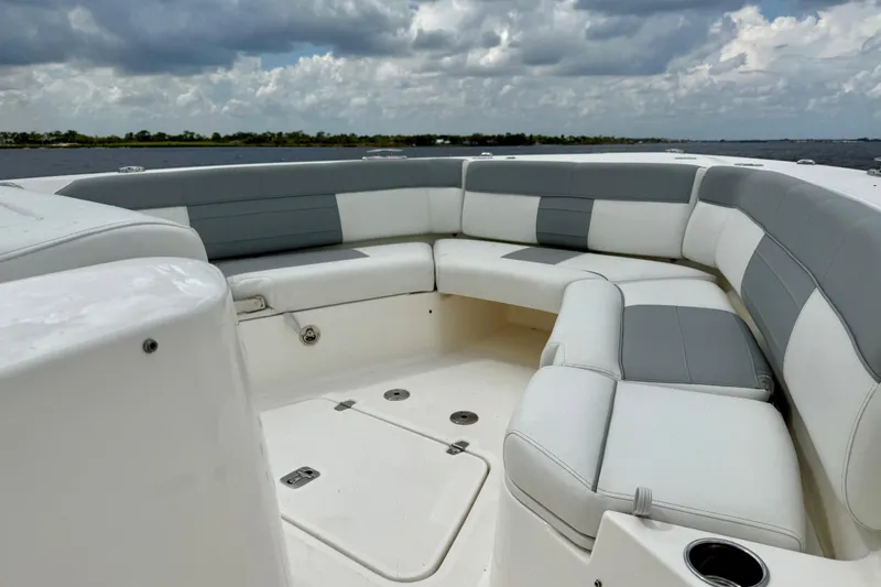 Slide: The Image of 2020 Pursuit S 408 Sport boat with spacious seating under cloudy skies. - 12