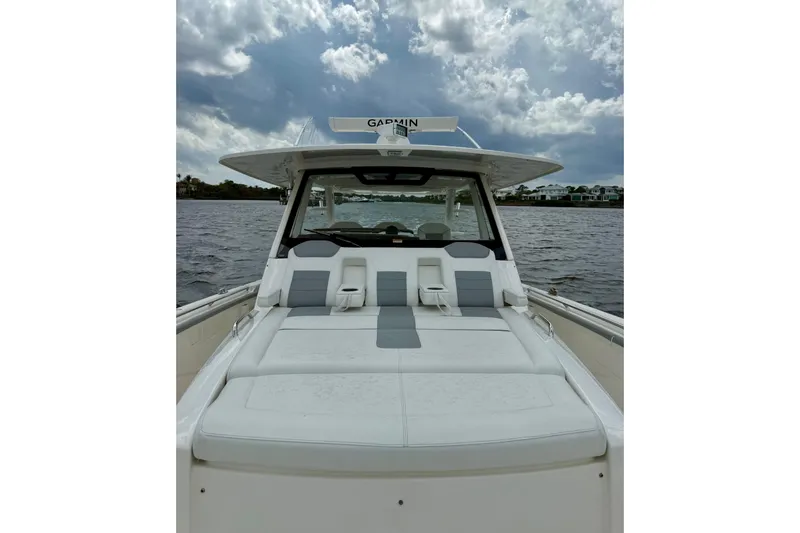 Slide: The Image of 2020 Pursuit S 408 Sport boat with cushioned seating on a cloudy day. - 17