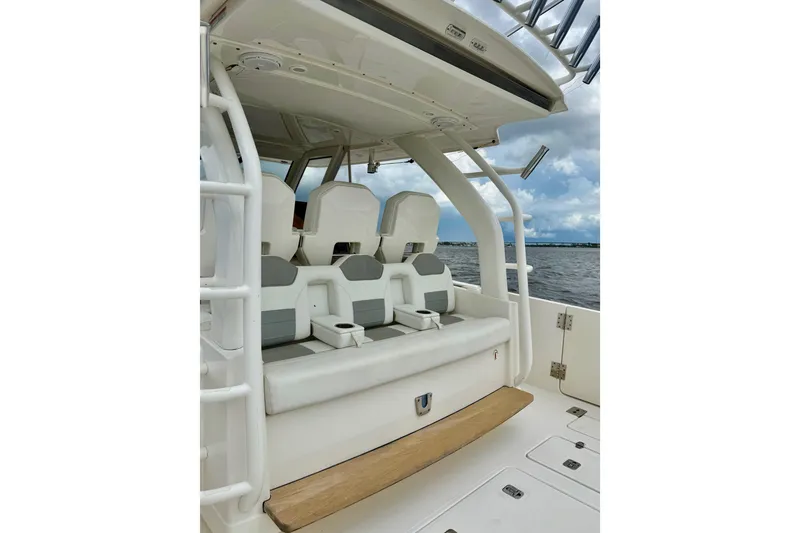 Slide: The Image of 2020 Pursuit S 408 Sport boat interior with cushioned seating and ocean view. - 23