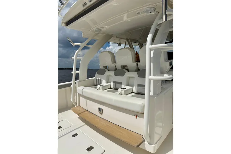 Slide: The Image of 2020 Pursuit S 408 Sport boat interior with cushioned seating and cup holders. - 24