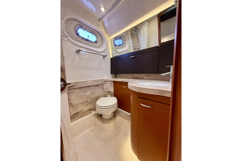 Slide: The Image of Luxurious bathroom in 2020 Pursuit S 408 Sport boat with modern fixtures and wood cabinetry. - 29