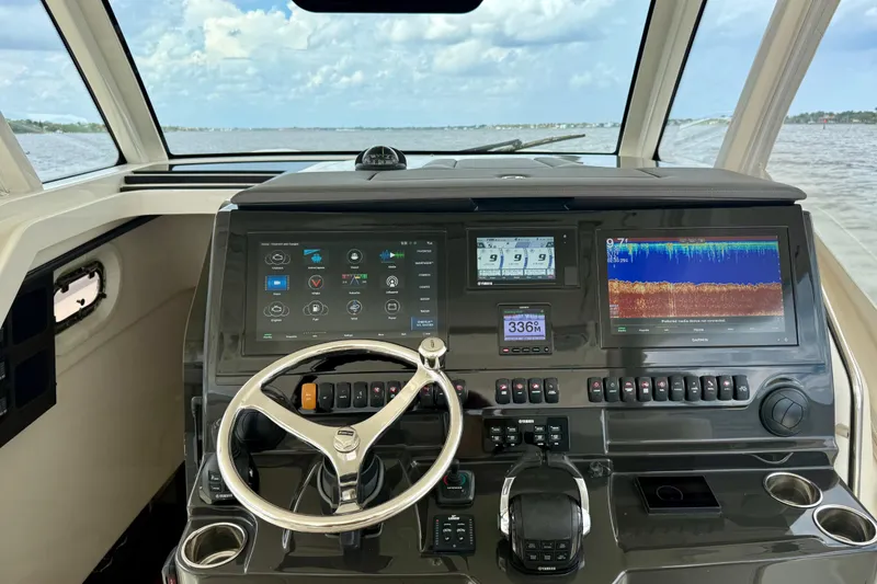 Slide: The Image of 2020 Pursuit S 408 Sport boat dashboard with advanced navigation and control systems. - 4