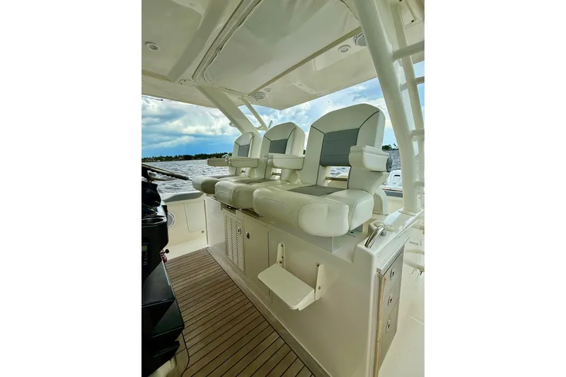 Slide: The Image of 2020 Pursuit S 408 Sport boat interior with luxurious seating and ocean view. - 9