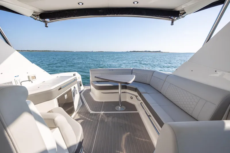 Slide: The Image of 2024 Sea Ray Sundancer 320 Outboard interior with elegant seating and ocean view. - 17