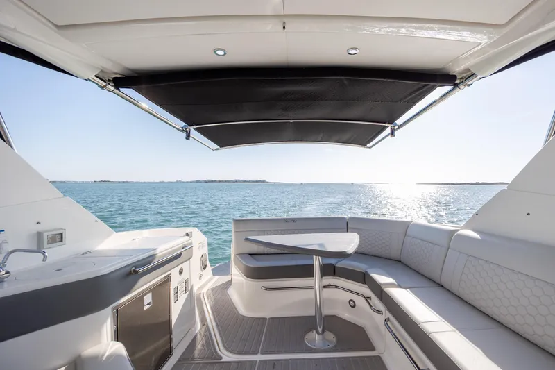 Slide: The Image of Luxurious 2024 Sea Ray Sundancer 320 Outboard interior with ocean view and seating area. - 18