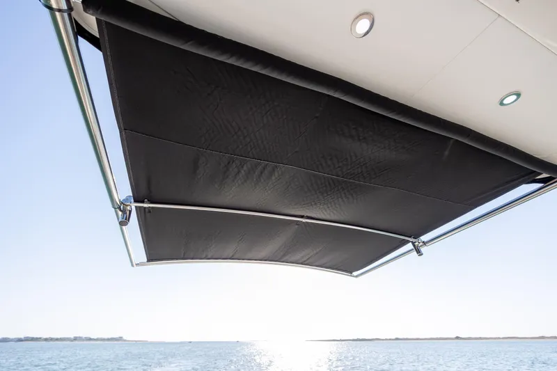 Slide: The Image of 2024 Sea Ray Sundancer 320 Outboard sunshade over ocean view. - 19