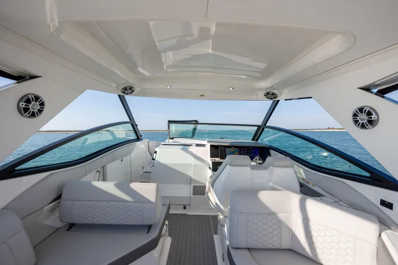 Slide: The Image of 2024 Sea Ray Sundancer 320 Outboard helm with steering wheel and control panel. - 26