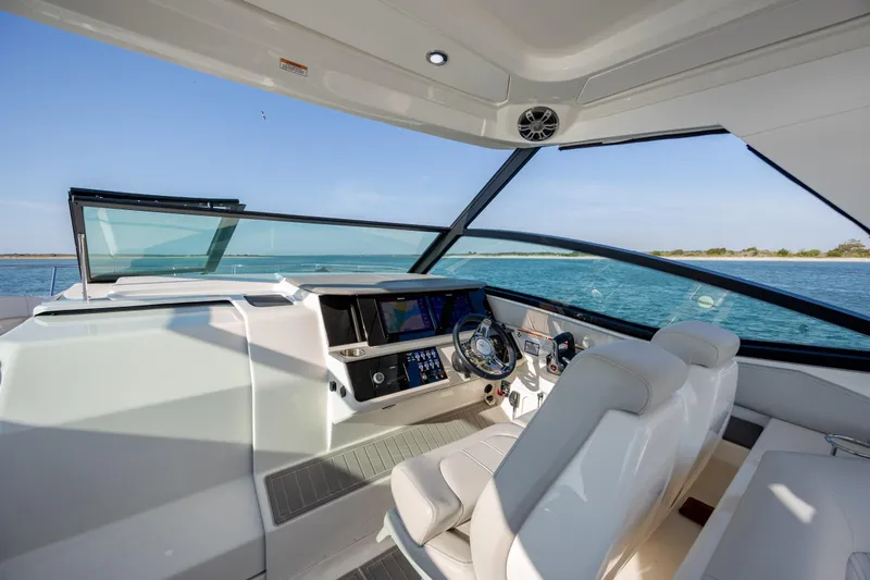Slide: The Image of 2024 Sea Ray Sundancer 320 Outboard cockpit with modern design and panoramic water views. - 27