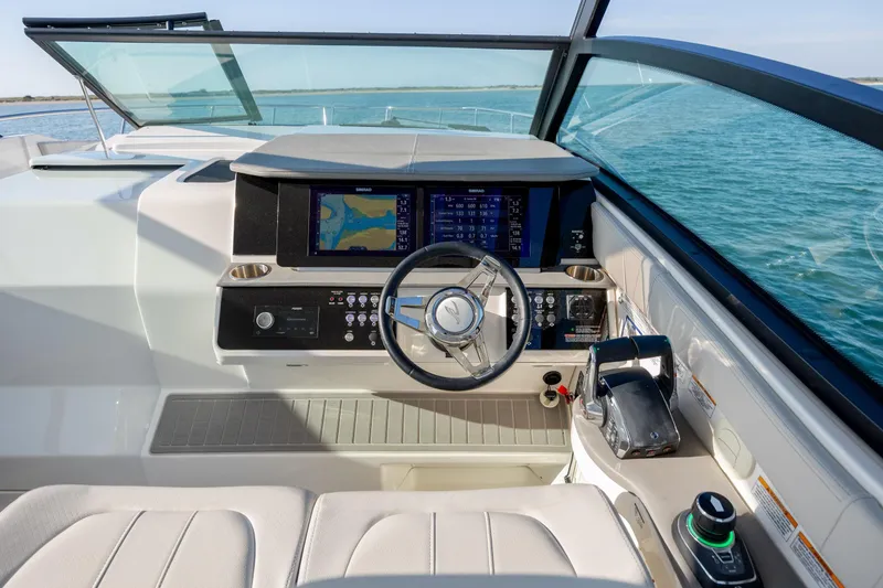 Slide: The Image of 2024 Sea Ray Sundancer 320 Outboard cruising on open water under clear blue skies. - 29