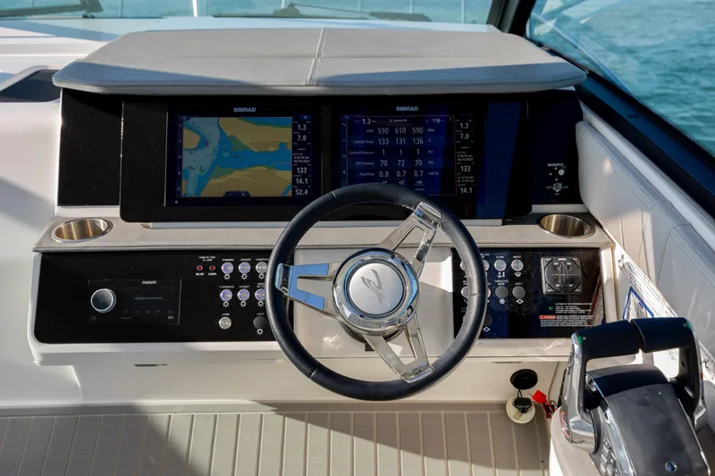 Slide: The Image of 2024 Sea Ray Sundancer 320 Outboard cruising on open water under bright sun. - 30
