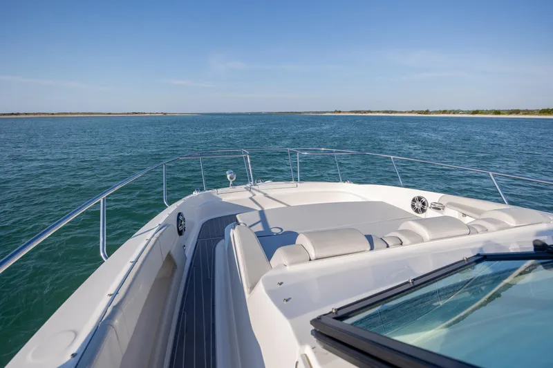 Slide: The Image of 2024 Sea Ray Sundancer 320 Outboard cabin interior with modern seating and kitchenette. - 33