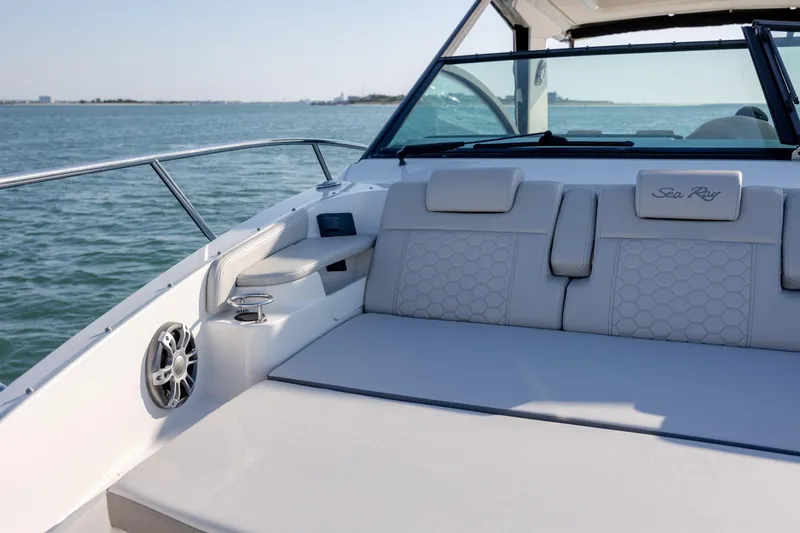 Slide: The Image of 2024 Sea Ray Sundancer 320 Outboard cabin with TV, speakers, and elegant seating. - 35