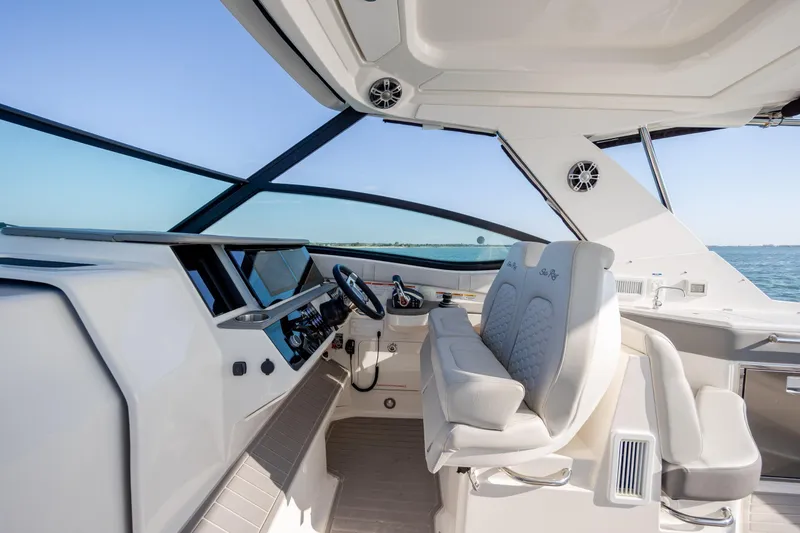 Slide: The Image of Engine compartment of 2024 Sea Ray Sundancer 320 Outboard, featuring red machinery and wiring. - 44