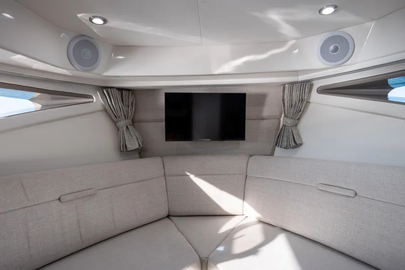 Slide: The Image of 2024 Sea Ray Sundancer 320 Outboard with open storage bag on deck, cruising on water. - 48