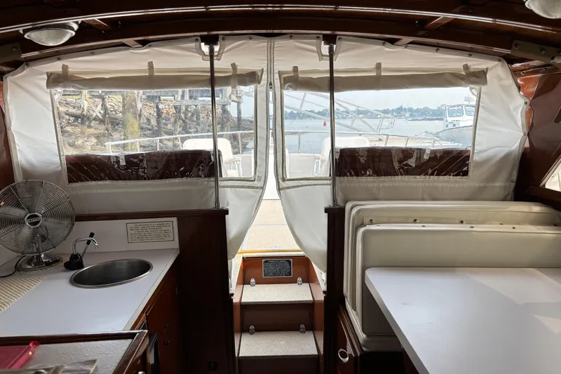 Slide: The Image of Interior view of 1967 Lyman Islander 30 boat with kitchenette and seating area. - 15
