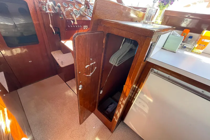 Slide: The Image of 1967 Lyman Islander 30 interior with wooden cabinetry and nautical instruments. - 19