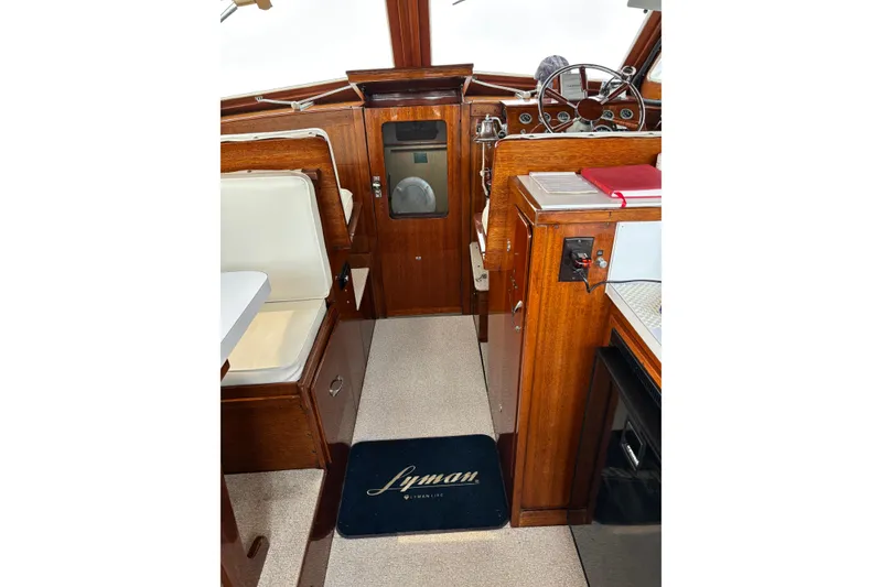 Slide: The Image of Interior of a 1967 Lyman Islander 30 boat with wooden finishes and steering wheel. - 22
