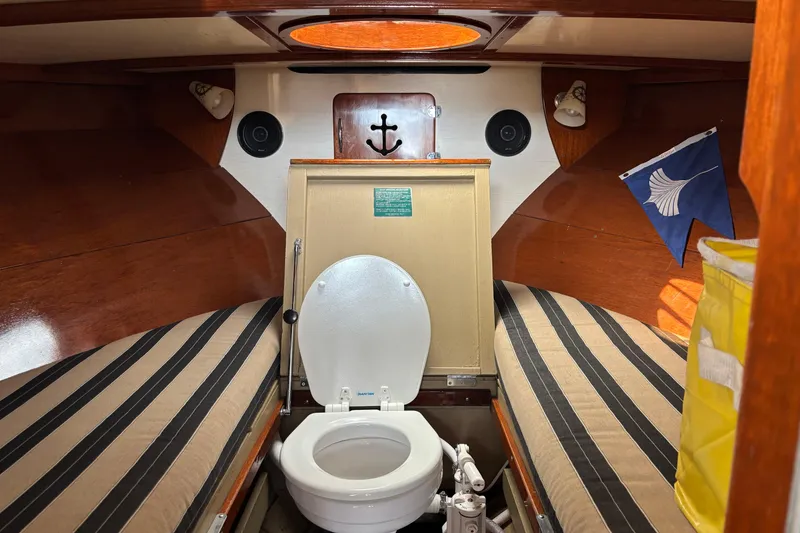 Slide: The Image of Interior of 1967 Lyman Islander 30 boat with toilet and striped cushions. - 29