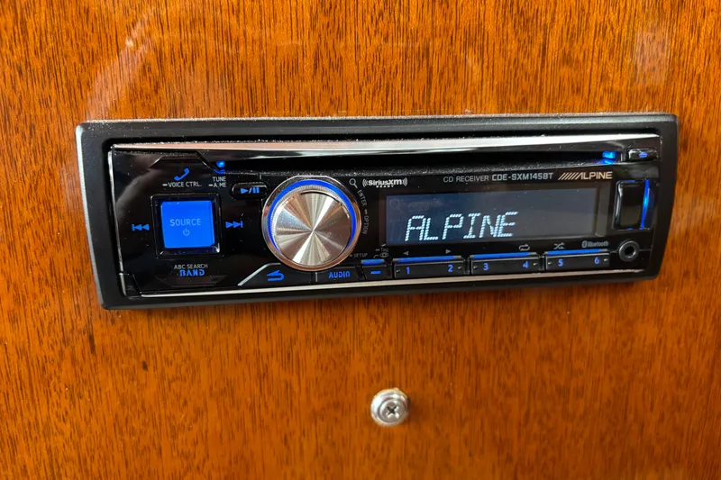Slide: The Image of Alpine CD receiver installed on 1967 Lyman Islander 30 boat's wooden dashboard. - 31