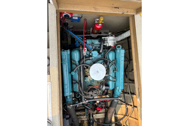 Slide: The Image of 1967 Lyman Islander 30 engine compartment with visible wiring and components. - 32