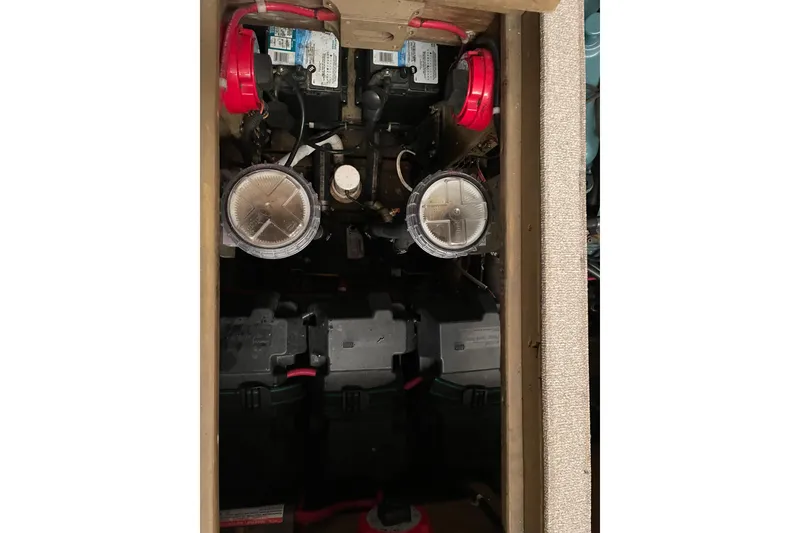 Slide: The Image of Engine compartment of a 1967 Lyman Islander 30 boat, showing dual batteries and components. - 34