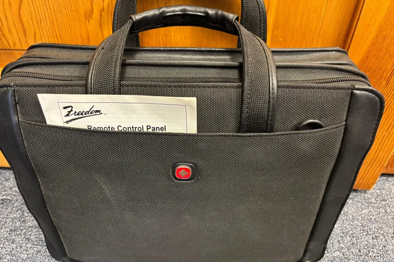 Slide: The Image of Black briefcase with a "Freedom Remote Control Panel" document in the front pocket. - 35