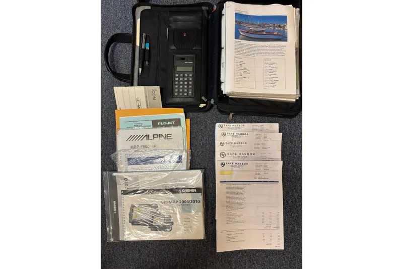 Slide: The Image of Documents and manuals for a 1967 Lyman Islander 30 boat, including navigation and equipment guides. - 37