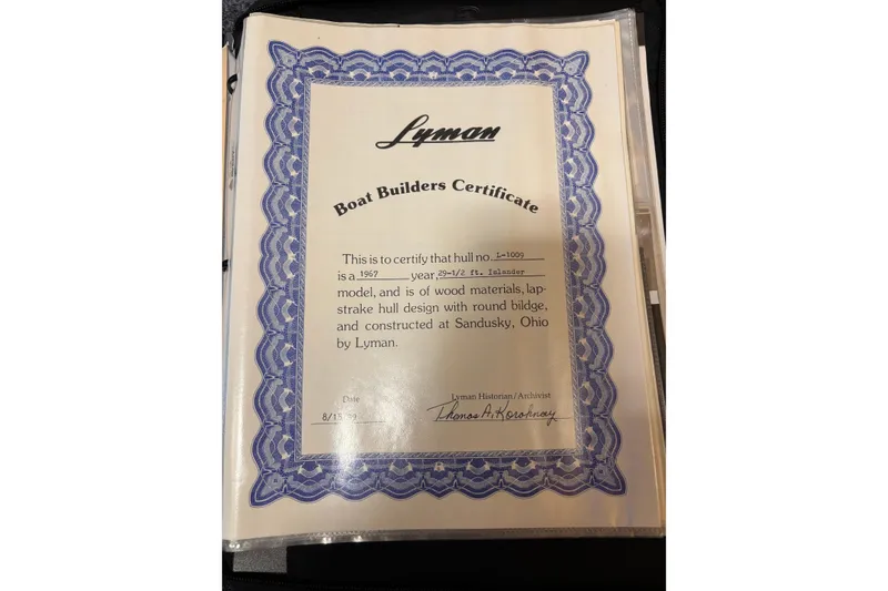 Slide: The Image of Lyman Islander 30 Boat Builders Certificate, 1967, featuring blue decorative border. - 39