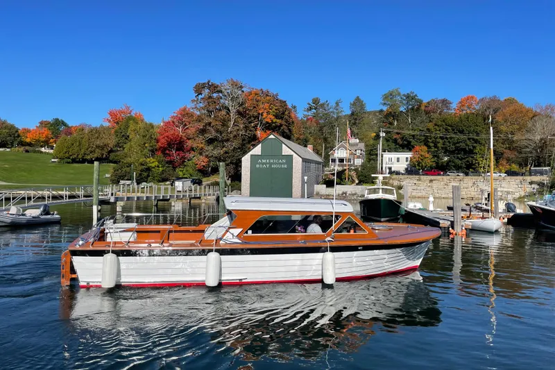 Slide: The Image of Vintage 1967 Lyman Islander 30 boat docked in scenic marina with autumn foliage. - 4