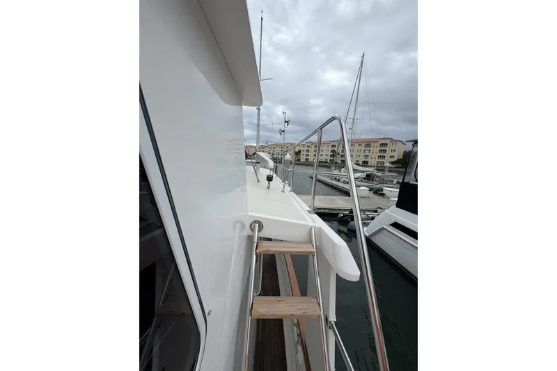 Slide: The Image of 2005 Kadey-Krogen 44 yacht side view with marina background. - 13