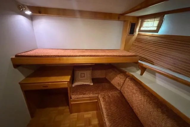 Slide: The Image of Cozy cabin interior of 2005 Kadey-Krogen 44 with wooden furnishings and cushioned seating. - 28