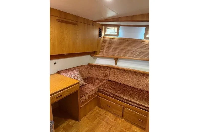 Slide: The Image of Interior of 2005 Kadey-Krogen 44 yacht with wooden cabinetry and cozy seating area. - 33