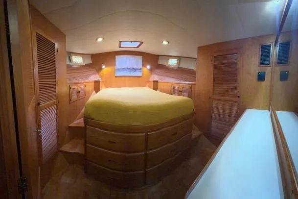 Slide: The Image of Luxurious 2005 Kadey-Krogen 44 yacht bedroom with wood paneling and cozy lighting. - 35
