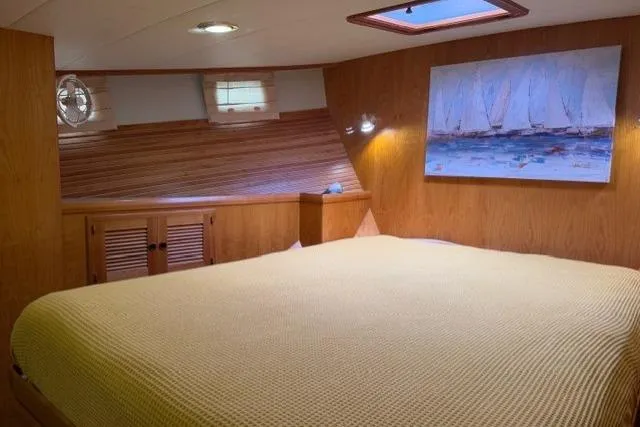 Slide: The Image of Cozy bedroom in 2005 Kadey-Krogen 44 yacht with nautical decor and wood paneling. - 36