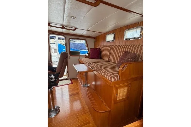 Slide: The Image of Interior of 2005 Kadey-Krogen 44 yacht with striped seating and wooden finishes. - 39