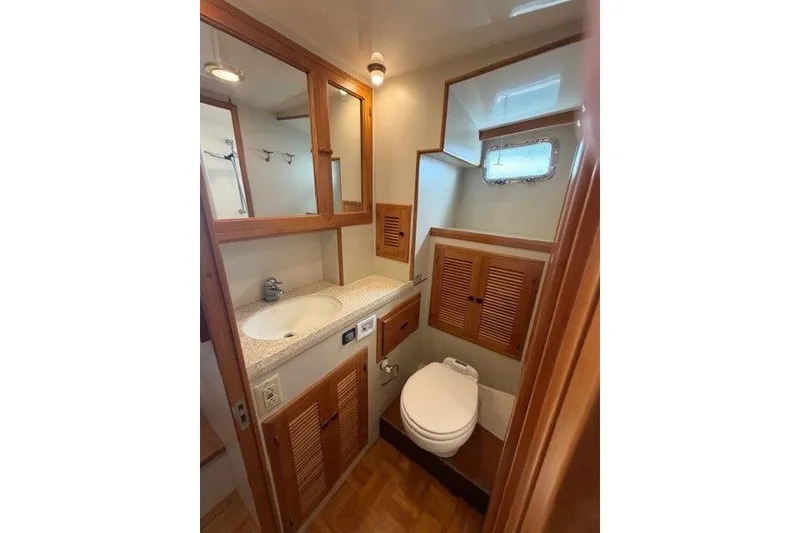 Slide: The Image of 2005 Kadey-Krogen 44 yacht bathroom with wooden cabinetry and compact design. - 41