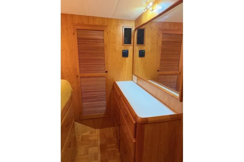 Slide: The Image of Kadey-Krogen 44 (2005) interior with wooden cabinetry and mirror in a cozy cabin setting. - 42