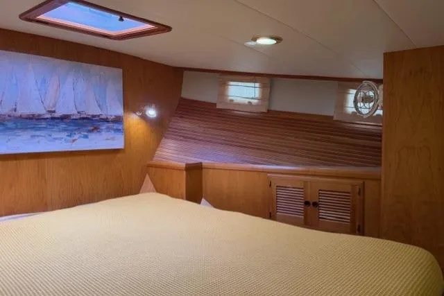 Slide: The Image of Cozy cabin interior of 2005 Kadey-Krogen 44 yacht with wooden paneling and artwork. - 47
