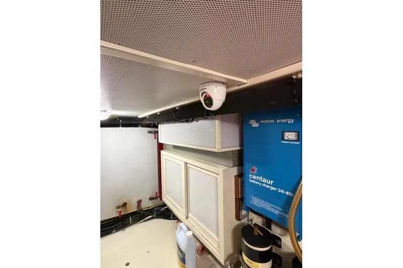 Slide: The Image of Engine room of 2005 Kadey-Krogen 44 with security camera and battery charger. - 54