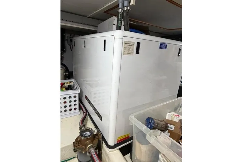 Slide: The Image of Engine room of 2005 Kadey-Krogen 44 yacht with equipment and storage containers. - 56