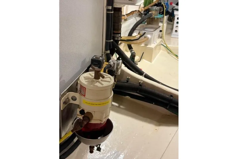 Slide: The Image of Engine room of 2005 Kadey-Krogen 44 yacht, featuring fuel filter and hoses. - 62