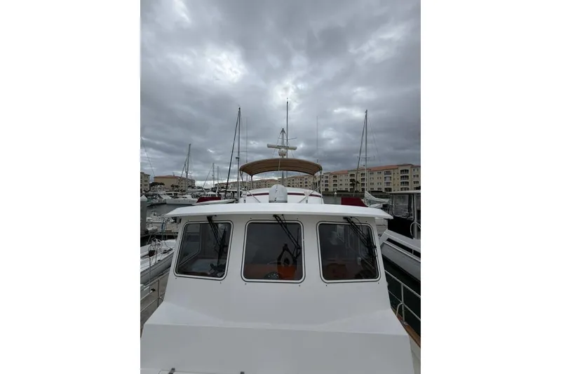 Slide: The Image of Kadey-Krogen 44 yacht from 2005 docked under cloudy skies at a marina. - 7