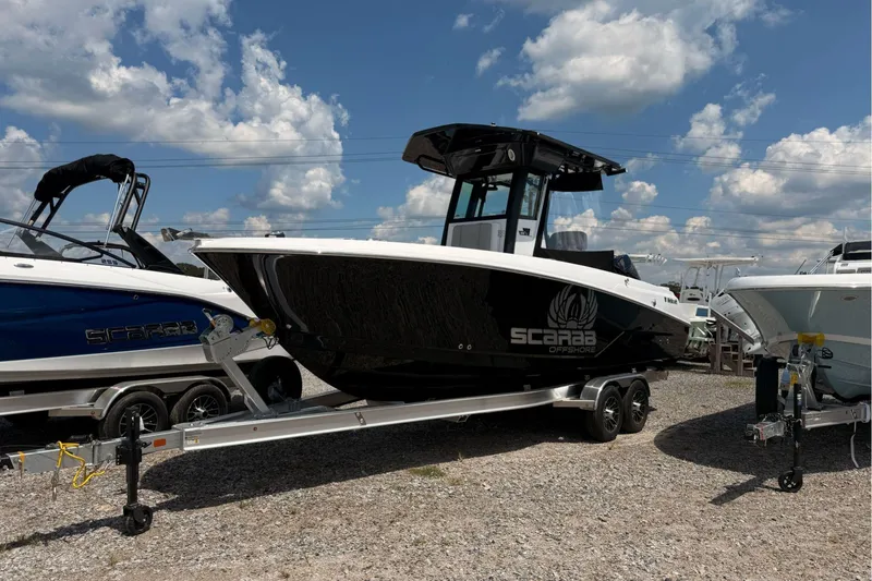 The Image of 2026 Wellcraft 243 Fisherman boat on trailer under a cloudy sky. - 0