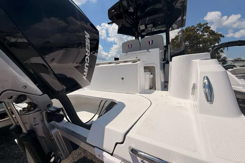 Slide: The Image of 2026 Wellcraft 243 Fisherman boat with Mercury engine, showcasing sleek design and spacious deck. - 10