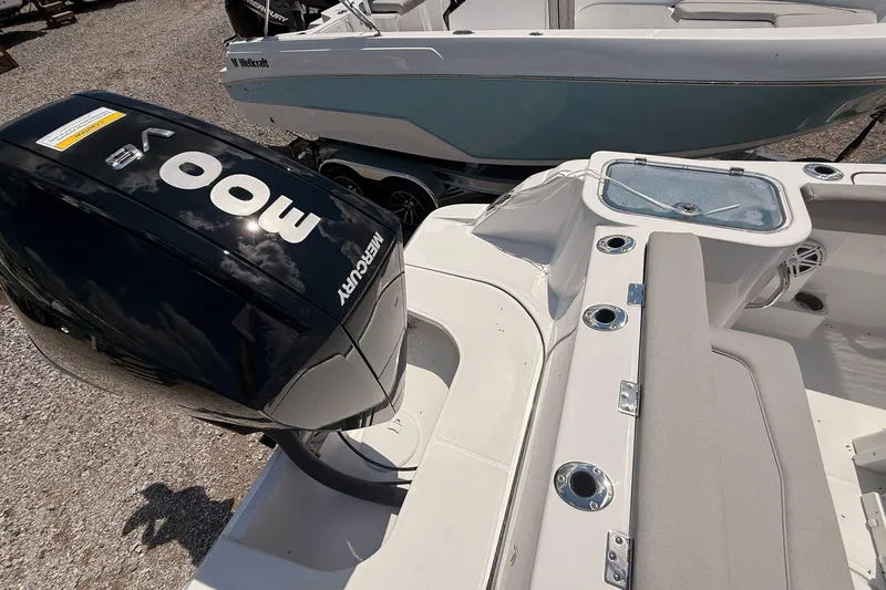 Slide: The Image of 2026 Wellcraft 243 Fisherman boat with Mercury 400 V8 engine, docked outdoors. - 13