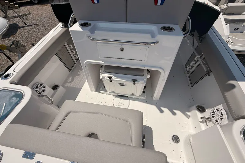 Slide: The Image of 2026 Wellcraft 243 Fisherman boat interior with seating, storage, and cooler. - 14