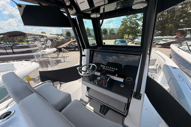 Slide: The Image of 2026 Wellcraft 243 Fisherman boat interior with modern dashboard and steering wheel. - 15