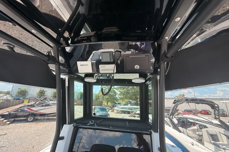 Slide: The Image of Interior view of 2026 Wellcraft 243 Fisherman boat's control panel and electronics. - 16